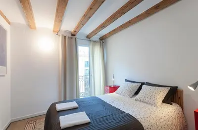 a bedroom with a bed with two towels on it at Central Azulete in Barcelona