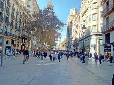 a busy city street with people walking and riding bikes at Central Azulete in Barcelona