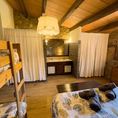 a bedroom with a bed with a teddy bear on it at Ca l'Esclatat in Santa María de Palautordera