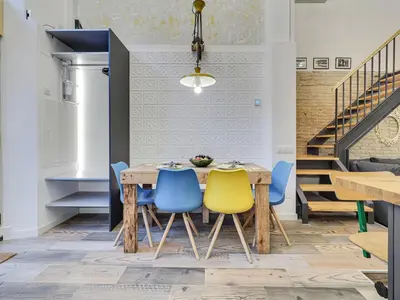 a dining room with a wooden table and blue chairs at Concordia - Beautiful flat, spacious, central 4 rooms , 2 bath in Barcelona