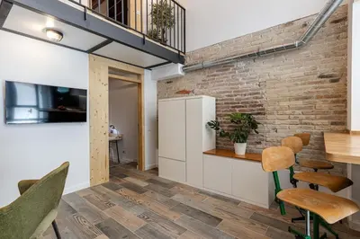 a kitchen and dining room with a brick wall at Concordia - Beautiful flat, spacious, central 4 rooms , 2 bath in Barcelona