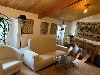 a living room with a couch and a table at Casa Añeja in Collbató