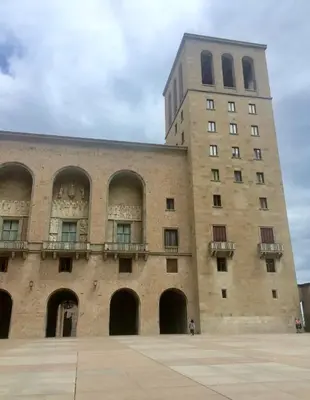 a large brick building with a tall tower at Casa Añeja in Collbató