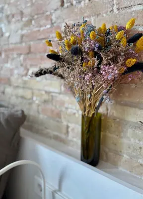 a vase of flowers sitting on a window sill at Cozy Suite in a historic house near the sea in Vilanova i la Geltrú