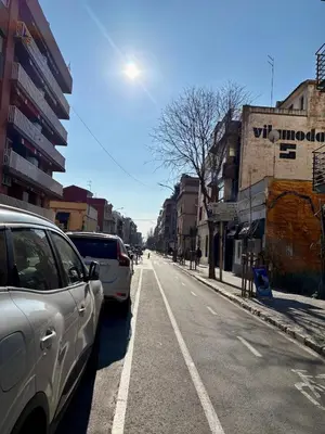 a street with cars parked on the side of the road at Cozy Suite in a historic house near the sea in Vilanova i la Geltrú