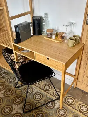 a wooden desk with a chair in a room at Cozy Suite in a historic house near the sea in Vilanova i la Geltrú