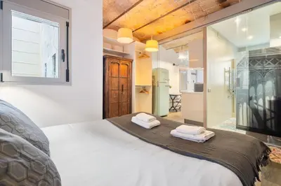 a bedroom with a large bed with two towels at Gràcia Monthly 1BR Sunny Private Terrace in Barcelona