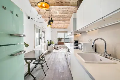 a kitchen with a sink and a table in it at Gràcia Monthly 1BR Sunny Private Terrace in Barcelona