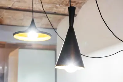 two lights hanging from the ceiling in a room at Gràcia Monthly 1BR Sunny Private Terrace in Barcelona