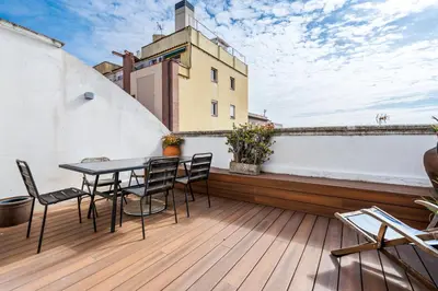 a balcony with a table and chairs on a building at Gràcia Monthly 1BR Sunny Private Terrace in Barcelona