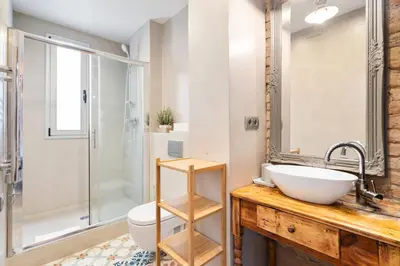 a bathroom with a sink and a toilet and a shower at Gràcia Monthly 1BR Sunny Private Terrace in Barcelona