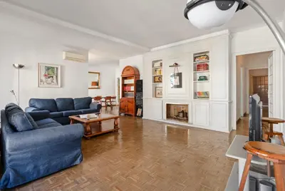 a living room with a blue couch and a table at 180m² 5BR Home Lift Terrace 32 Nights in Barcelona