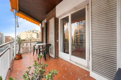 a balcony with a table and a table at 180m² 5BR Home Lift Terrace 32 Nights in Barcelona