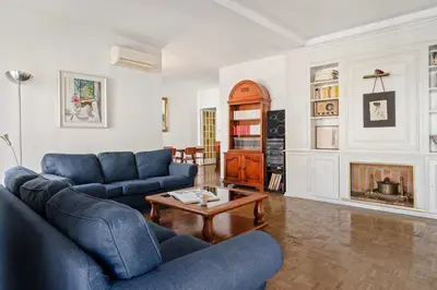a living room with two blue couches and a coffee table at 180m² 5BR Home Lift Terrace 32 Nights in Barcelona