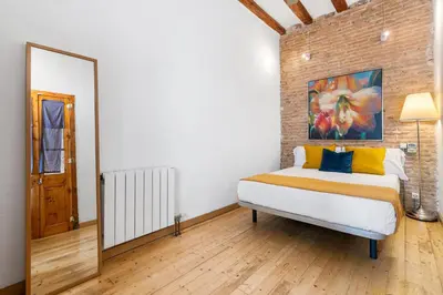 a kitchen with white cabinets and a stove top oven at Historic El Born 2BR Monthly Stay Workspace in Barcelona