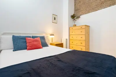 a kitchen with a white table with a bowl of fruit on it at Historic El Born 2BR Monthly Stay Workspace in Barcelona