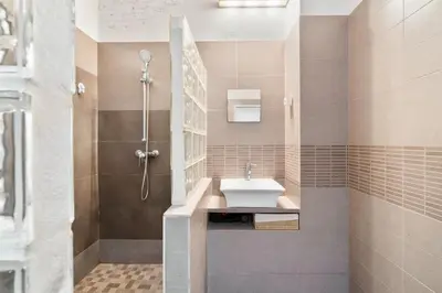 a small bedroom with a bed and a night stand at Historic El Born 2BR Monthly Stay Workspace in Barcelona