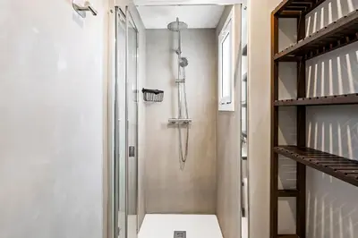 a shower with a glass door in a bathroom at 55m² Monthly Base w Terrace AC in Barcelona