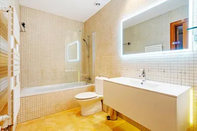 a bathroom with a sink and a toilet and a mirror at Quiet, vibrant 2 bedroom in pedestrian Eixample in Barcelona
