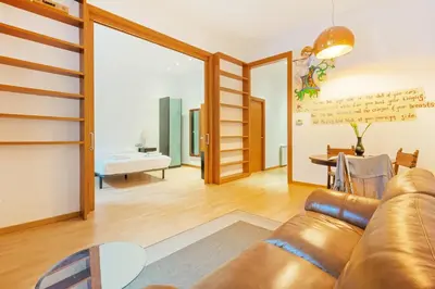 a living room with a couch and a loft bed at Quiet, vibrant 2 bedroom in pedestrian Eixample in Barcelona