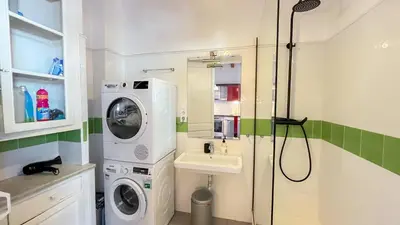 a bathroom with a washing machine and a sink at 