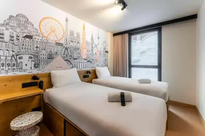 a hotel room with two beds and a window at easyHotel Barcelona La Sagrera in Barcelona