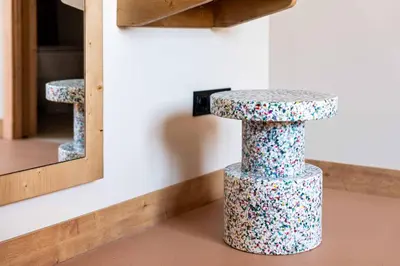 a colorful stool in front of a mirror at easyHotel Barcelona La Sagrera in Barcelona