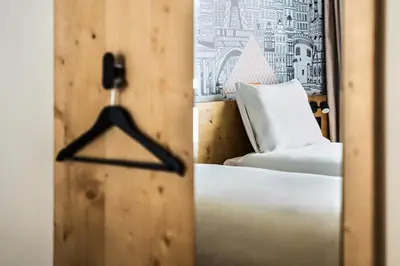 a bedroom door with a bed and a chair at easyHotel Barcelona La Sagrera in Barcelona