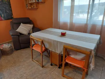 a table with two chairs and a couch in a room at Casa del Campo in Els Hostalets