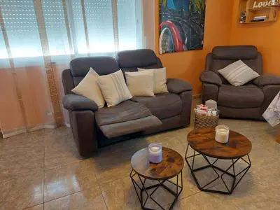 a living room with a couch and two tables at Casa del Campo in Els Hostalets