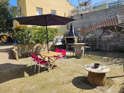 a table and chairs with a table and an umbrella at Casa del Campo in Els Hostalets