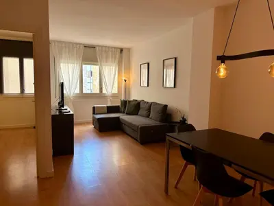 a living room with a couch and a table at Spacious 1 bedroom home in Bonanova in Barcelona
