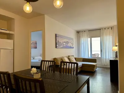 a living room with a table and a couch at Spacious 1 br home in Bonanova in Barcelona