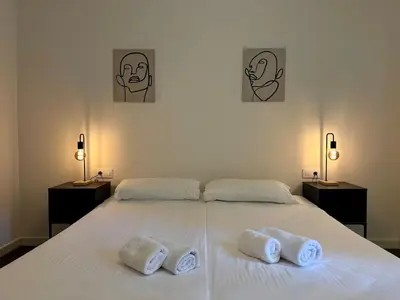 a bedroom with a bed with two towels on it at Spacious 1 br home in Bonanova in Barcelona
