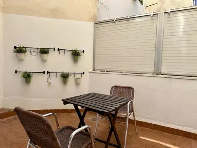 a table and chairs with plants on a wall at Spacious 1 br home in Bonanova in Barcelona