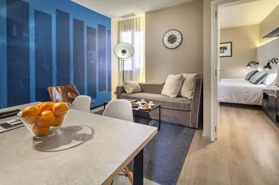 a living room with a table and a couch at Habitat Apartments Cool Jazz in Barcelona