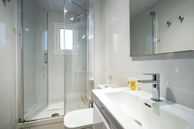 a bathroom with a shower and a sink and a toilet at Habitat Apartments Cool Jazz in Barcelona
