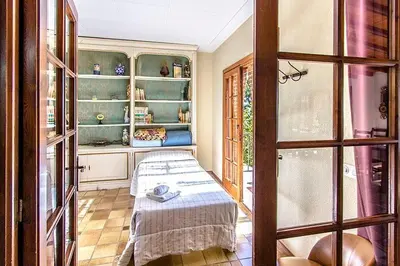 a room with a table in a room with shelves at Casa Rural CAN PANXA in Sant Pere de Vilamajor