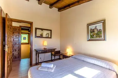 a bedroom with a large bed and a desk at Casa Rural CAN PANXA in Sant Pere de Vilamajor