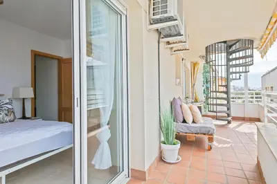 a room with a bed and a glass door at Apartamento Cubelles Molí Baix in Cubelles