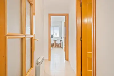 a hallway with an open door to a room at Apartamento Cubelles Molí Baix in Cubelles