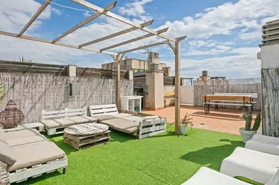 a pergola on a patio with green grass at Apartamento Cubelles Molí Baix in Cubelles