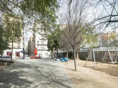 a park with a playground with blue balls and trees at Winahost La Barceloneta in Barcelona