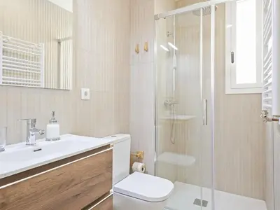 a bathroom with a shower and a toilet and a sink at Winahost La Barceloneta in Barcelona