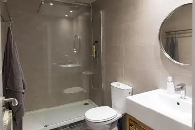 a bathroom with a shower and a toilet and a sink at Central Apartment in Barcelona
