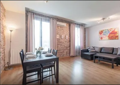 a living room with a table and a couch at Central Apartment in Barcelona