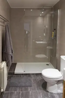 a bathroom with a shower and a toilet and a tub at Central Apartment in Barcelona