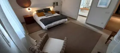 a bedroom with a bed and a table and chairs at A Country and Vineyard Retreat in San Martín Sarroca