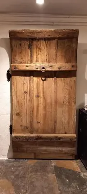 a wooden door in a room with a wall at A Country and Vineyard Retreat in San Martín Sarroca