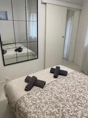 a bedroom with a bed with two black pillows on it at Apartamento Barcelona in Barcelona
